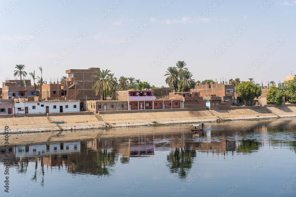 Traditional Egyptian villages on the bank of the river Nile. Views sailing on the cruise on the river Nile from Luxor to Aswer, Egypt