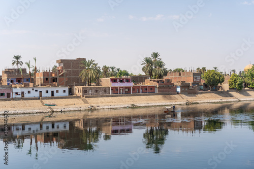 Traditional Egyptian villages on the bank of the river Nile. Views sailing on the cruise on the river Nile from Luxor to Aswer, Egypt