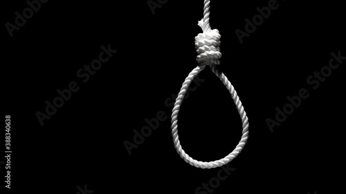 Rope noose on black background. Loop from a rope. Depression of burnout. Terrible life situation. Copy space. 