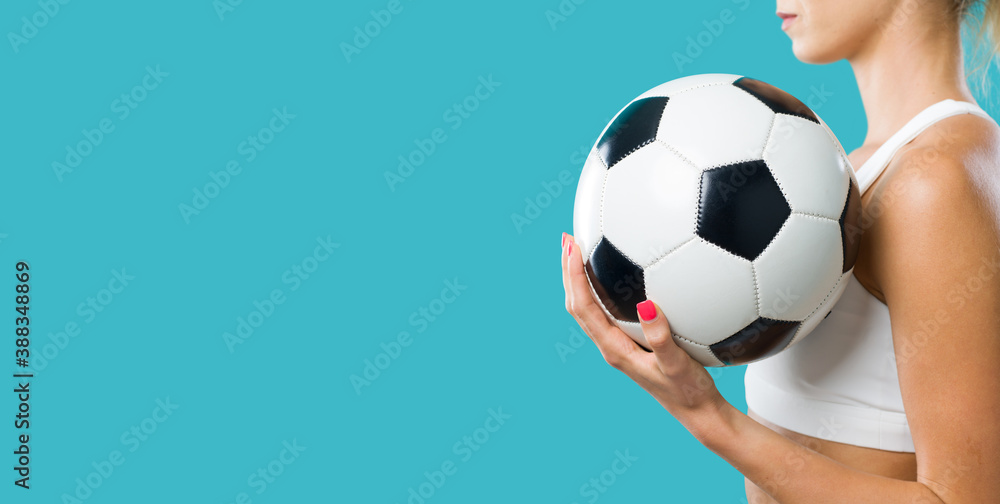 Sporty woman holding a soccer ball Sporty woman holding a soccer ball