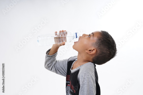 Schoolboy drinking mineral water