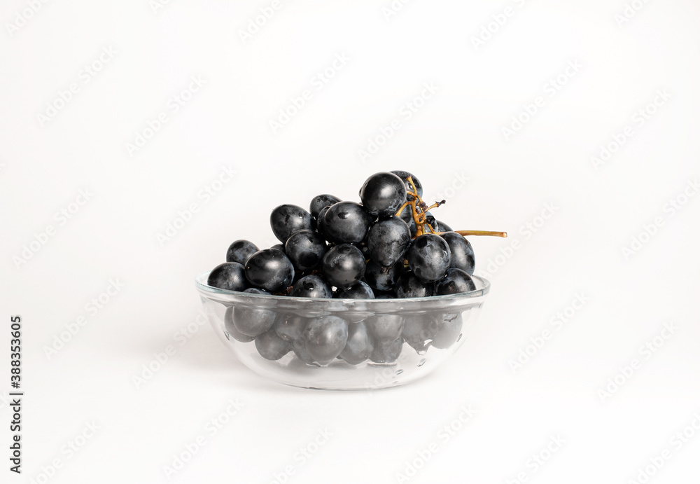 Juicy grapes on a white background in a plate Juicy grapes on a white background in a plate