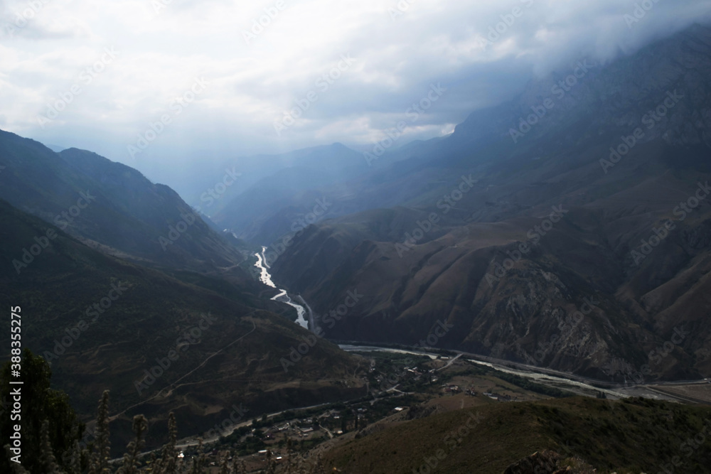 View of the mountains of the North Caucasus. Mountains in the clouds in summer View of the mountains of the North Caucasus. Mountains in the clouds in summer