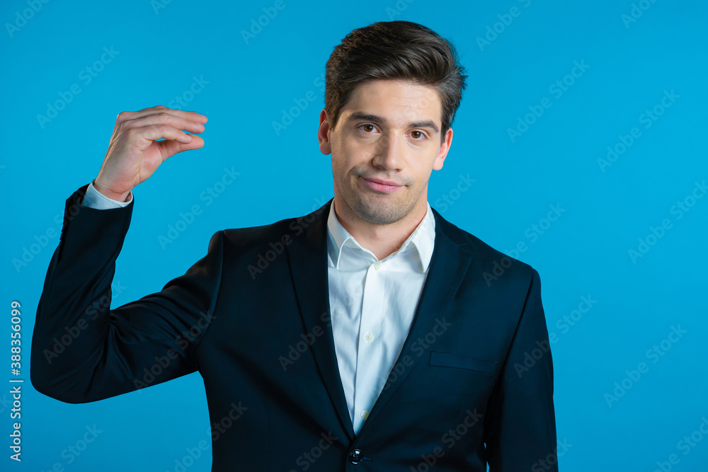 Handsome bored business man showing bla-bla-bla gesture with hands and rolling eyes isolated on blue background. Empty promises, blah concept. Lier Handsome bored business man showing bla-bla-bla gesture with hands and rolling eyes isolated on blue background. Empty promises, blah concept. Lier