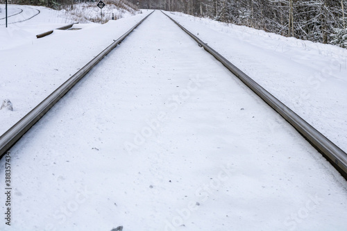 Railway in winter. Snow-covered railway tracks.