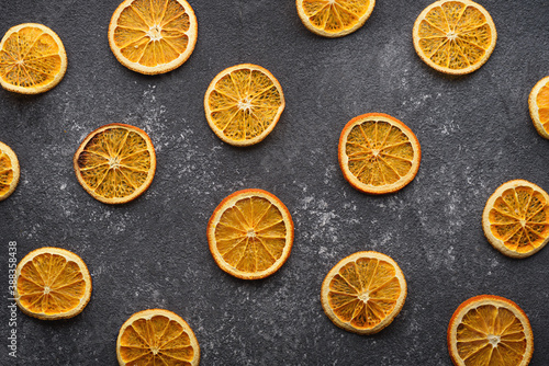 dried orange slices on gray background, kitchen background, top view