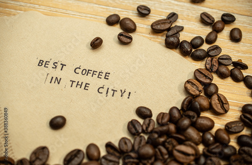 Best coffee in the city slogan on coffee filter with stamps and beans