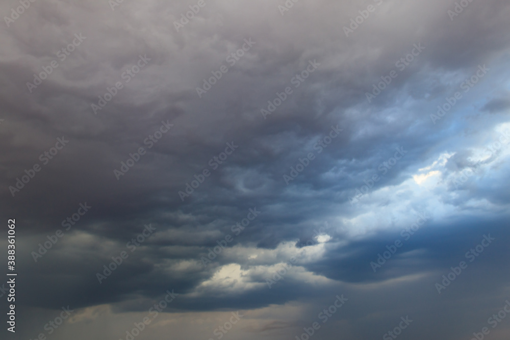 Dark storm clouds in sky before thunderstorm and rain. Dramatic sky background