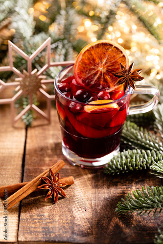 Christmas mulled wine with spices on a wooden rustic table.