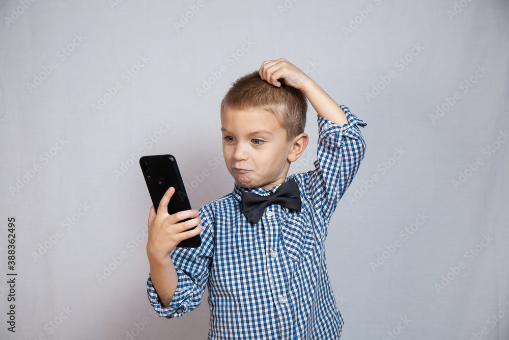 Fototapeta premium Boy with blue eyes on a gray background
