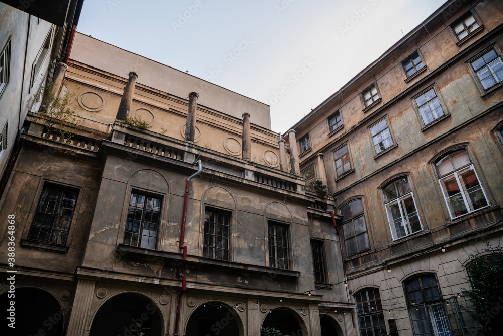 Сourtyard of old historical building of The College of Media and Journalism in the historic center during the autumn day, crumbling plaster and antique balcony in Prague, Czech Republic