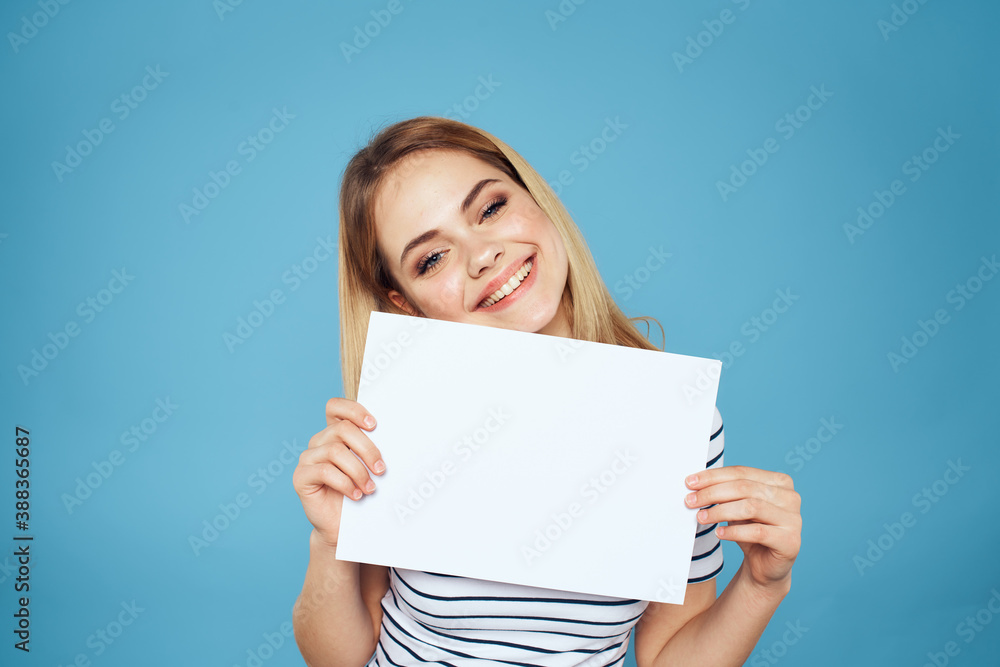 Woman holding sheet of paper striped T-shirt Copy Space cropped view blue background Woman holding sheet of paper striped T-shirt Copy Space cropped view blue background