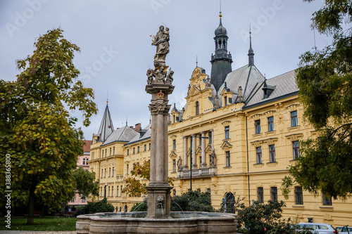 Fountain with a statue of St. Josefa at Charles Square near the renaissance building of Municipal Court and New Town Hall in the center of Prague, Czech Republic