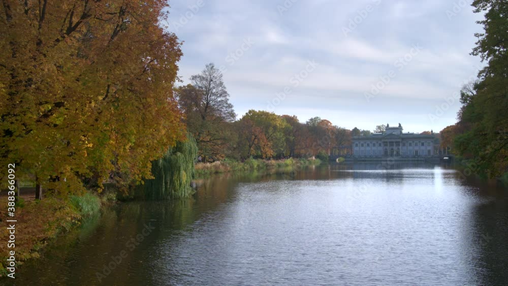WARSAW, POLAND - OCTOBER 25, 2020: Royal Palace on the Water in Lazienki Park, during autumn afternoon. Lazienki park is the largest park in Warsaw. WARSAW, POLAND - OCTOBER 25, 2020: Royal Palace on the Water in Lazienki Park, during autumn afternoon. Lazienki park is the largest park in Warsaw.