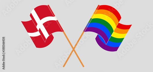 Crossed and waving flags of Denmark and LGBTQ