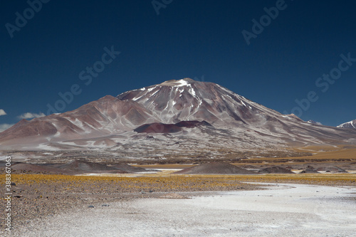 Volcanic landscape in the Andes mountain range. View of Volcano Incahuasi and natural salt flat in San Francisco pass, Catamarca, Argentina.  © Gonzalo