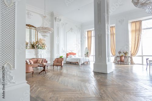 royal baroque style luxury posh interior of large room. extra white  full of day light. high ceiling and walls decorated by stucco