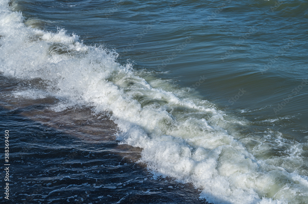 Fototapeta premium Sea wave with foam and splashes, close up, copy space