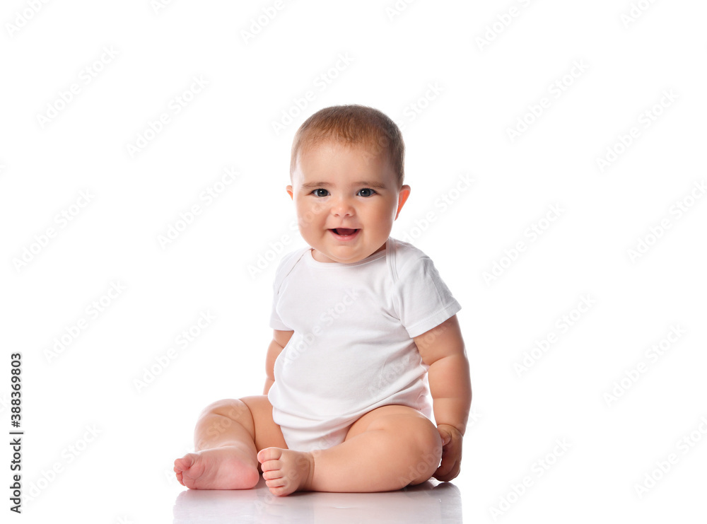 Little baby girl in white bodysuit sitting on the floor isolated on white. Little baby girl in white bodysuit sitting on the floor isolated on white.