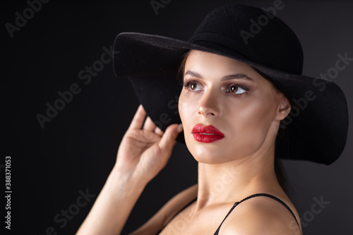 Beautiful woman in hat. Retro fashion. Dark Background. © Andrey Cherkasov