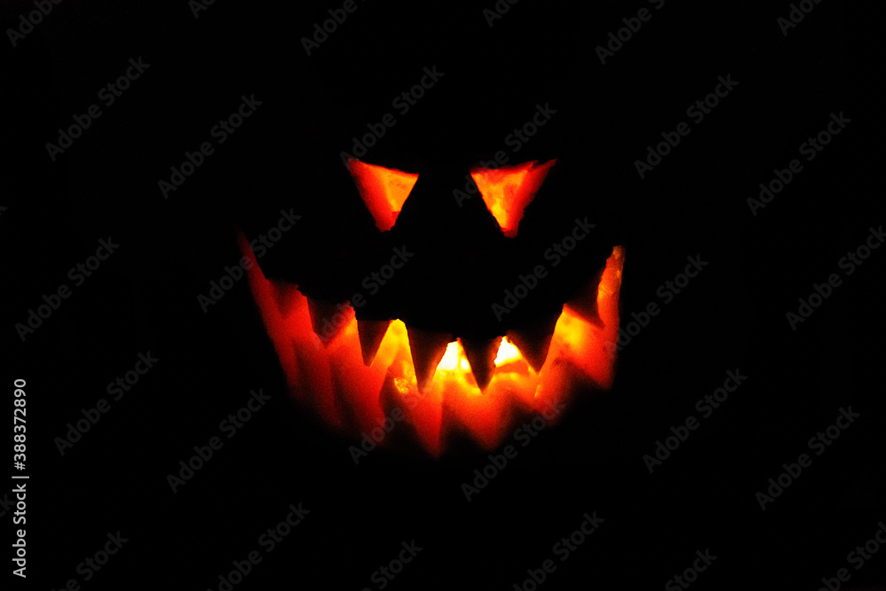 scary eyes and teeth glowing fiery Jack-o'-lantern face from a pumpkin on a halloween scary eyes and teeth glowing fiery Jack-o'-lantern face from a pumpkin on a halloween