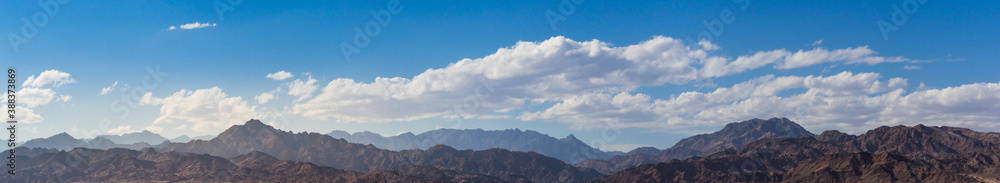 Mountain landscape with clouds over peaks for your travel concept, panoramic view. 
