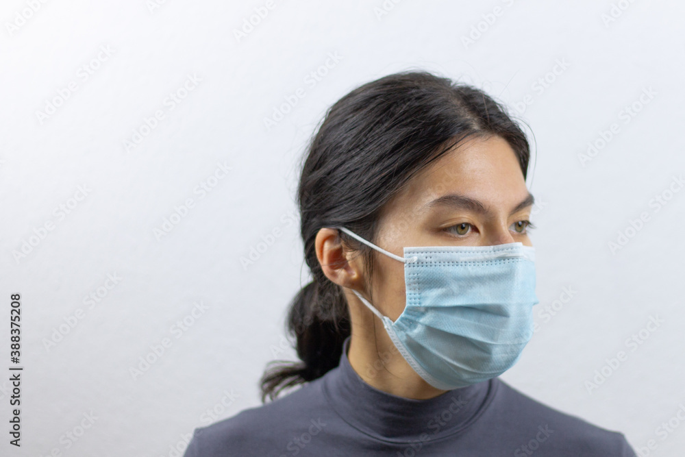 Asian woman wearing facial mask for protection from virus epidemic on white background Asian woman wearing facial mask for protection from virus epidemic on white background