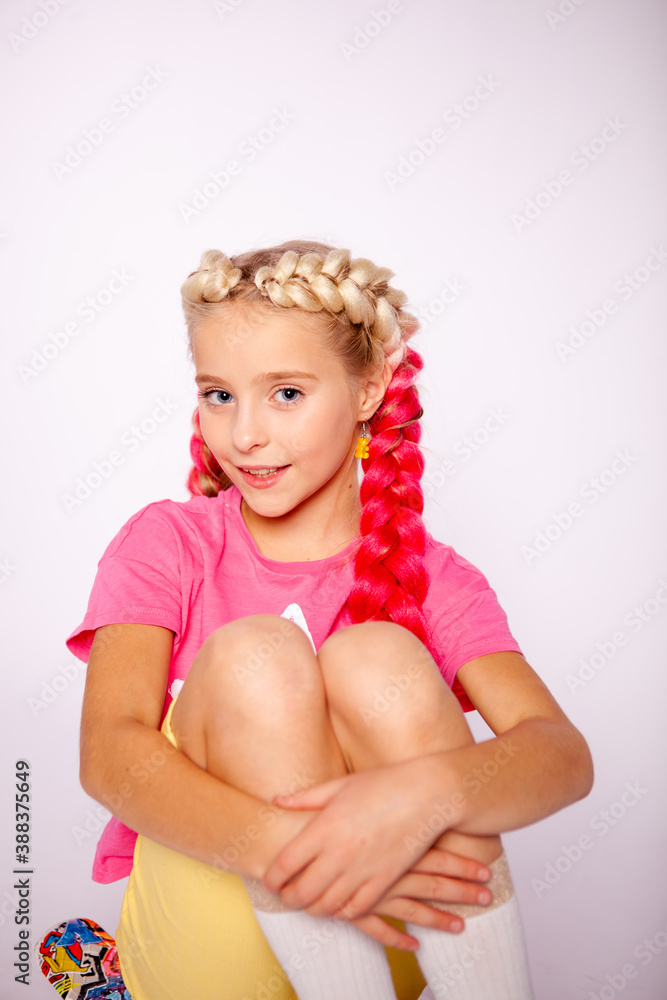 cute girl in bright colorful clothes and with colored braids cute girl in bright colorful clothes and with colored braids