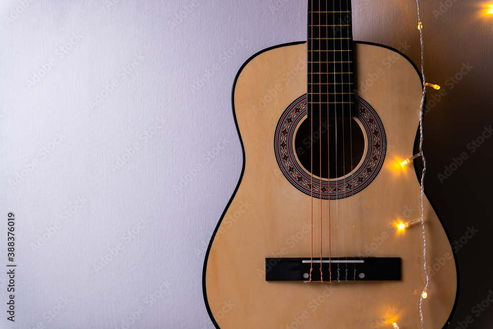 background from a guitar with a garland on a gray background. Concept: Beautiful Christmas background