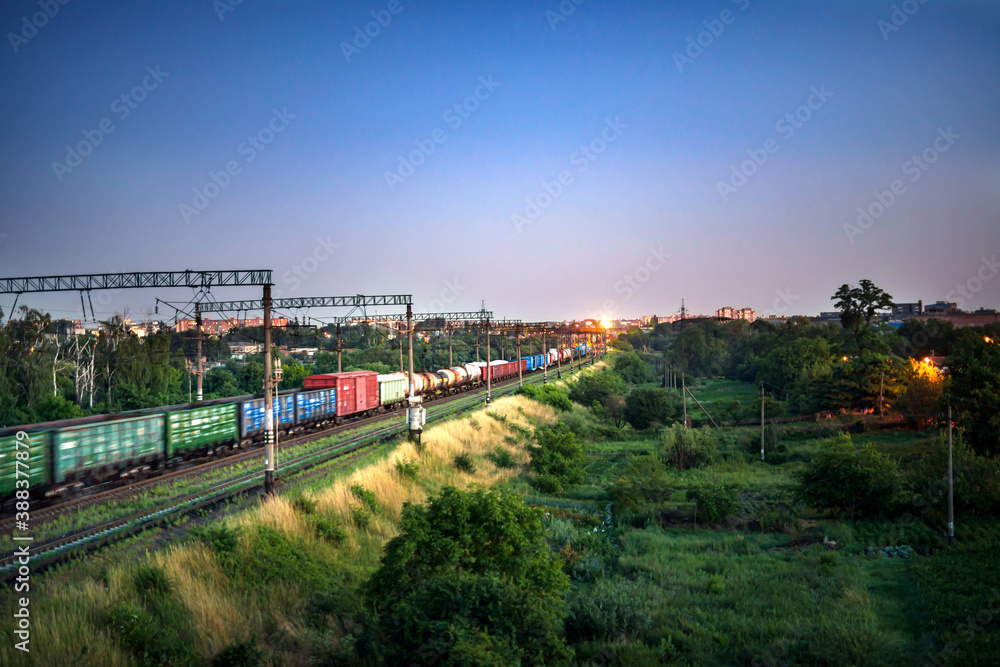 Train with freight cars while moving in the evening
