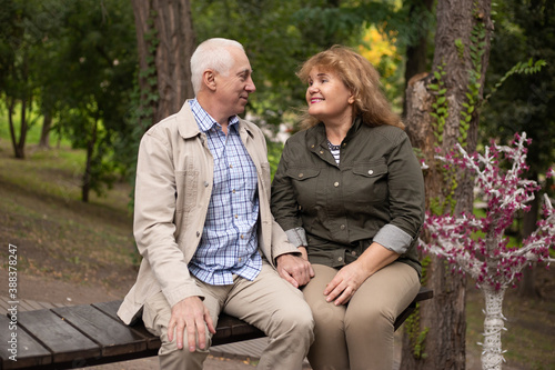 Mature couple in autumn park, senior couple relax in spring autumn time © Marharyta