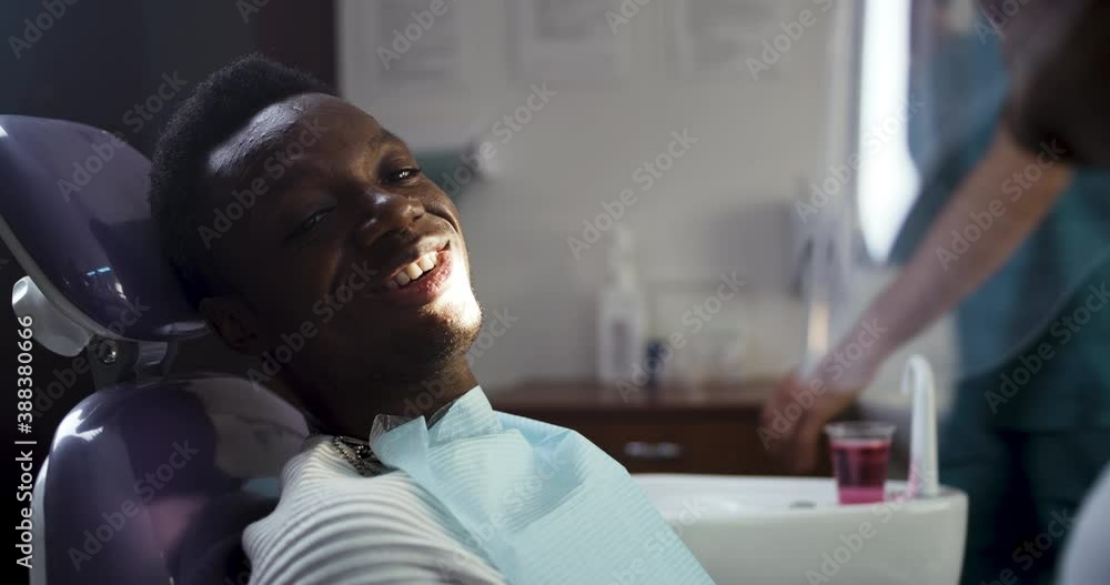 Smiling black teen visiting dentist