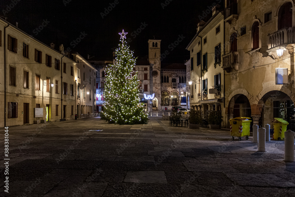 Naklejka premium View on Christmas tree in beautiful medieval town square, Vittorio Veneto, Italy. Concept: Italian historic centers, urban panoramas, urban Christmas decorations