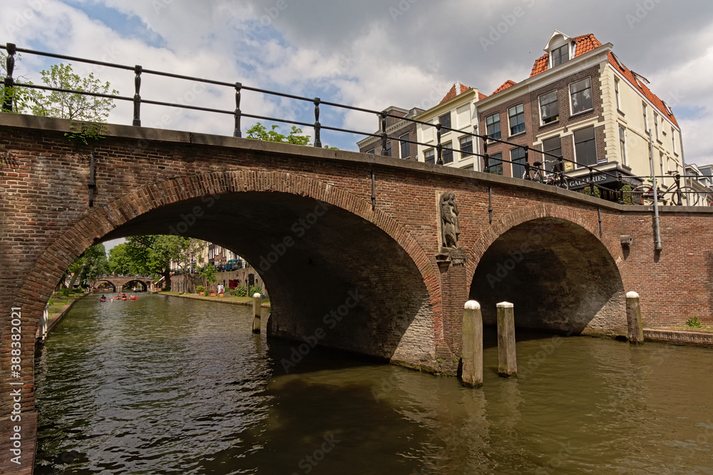 Brick stone arch bridge over `oudegracht` canal Utrecht, the Netherlands, low angle view 