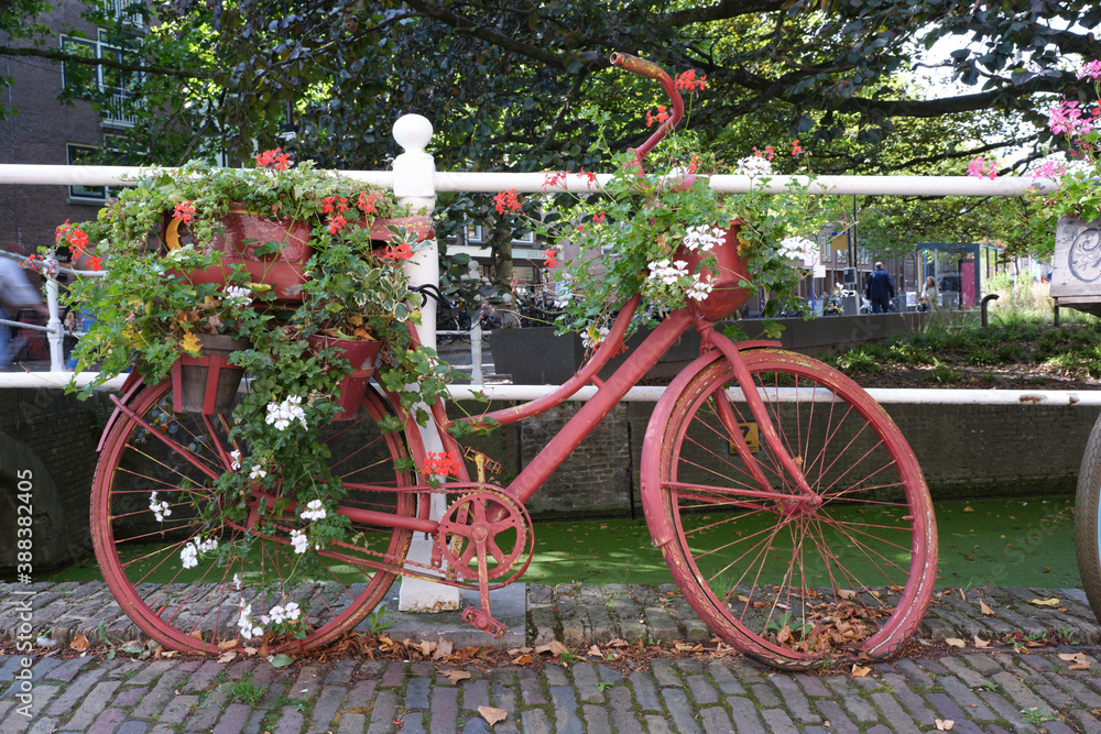 Old-fashioned city bike near a bridge over canal in the Old Town of Delft, Holland