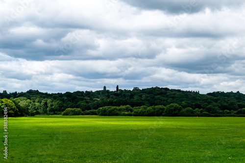 Beautifull vivid view for green and sunny field with trees and bright green grass and partial overcast, the Runnymede meadow in Old Windsor by Langham Pond, thousand year old picnic and polictic place