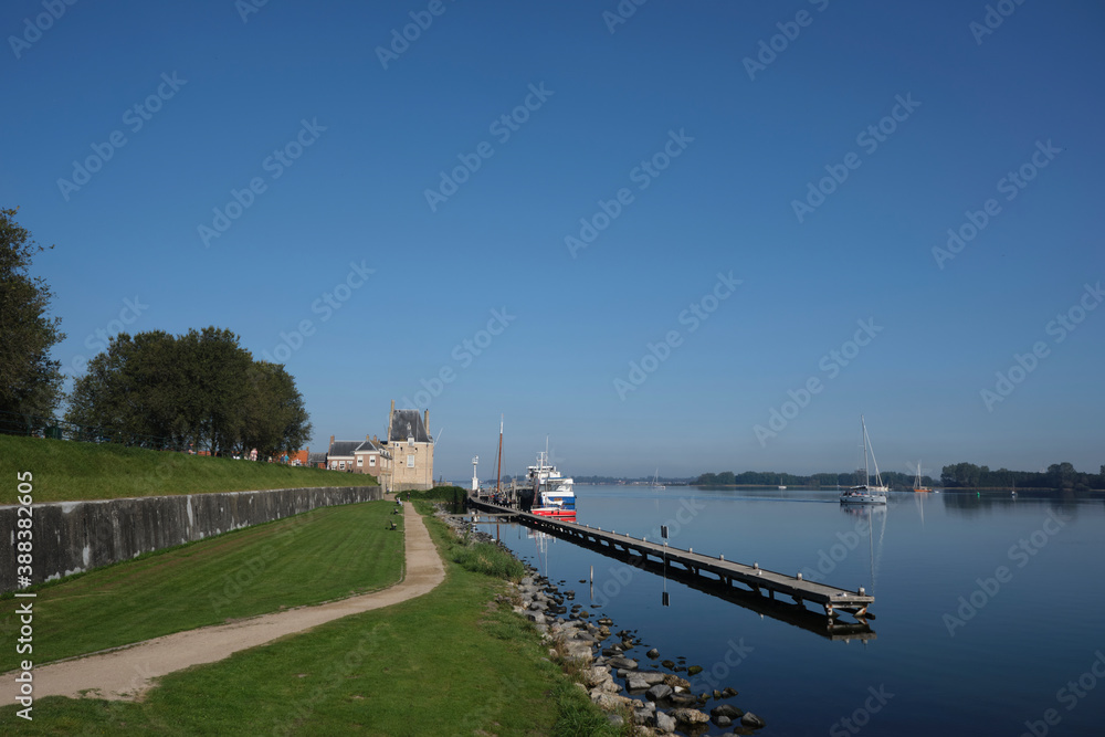 Veere, The Netherlands. Sailboat moored on the outer jetty at the Campveerse tower of the old fortified town of Veere