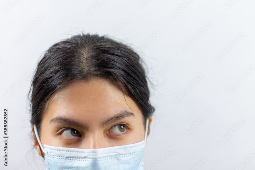 Asian woman wearing facial mask for protection from virus epidemic on white background Asian woman wearing facial mask for protection from virus epidemic on white background