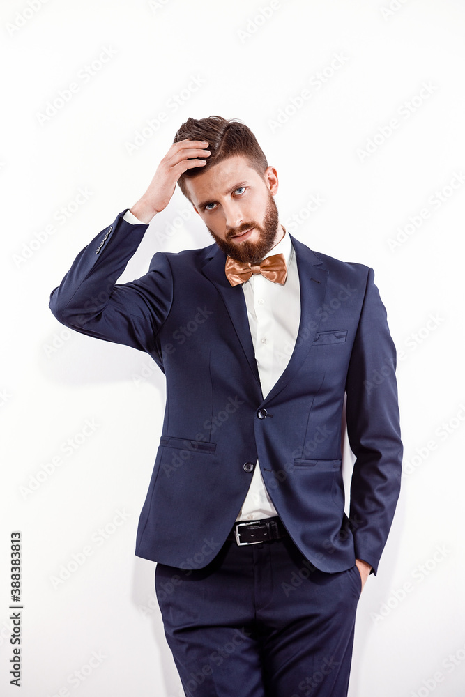 Elegant young handsome man in black classic costume. Studio fashion portrait. Isolated on white. Elegant young handsome man in black classic costume. Studio fashion portrait. Isolated on white.