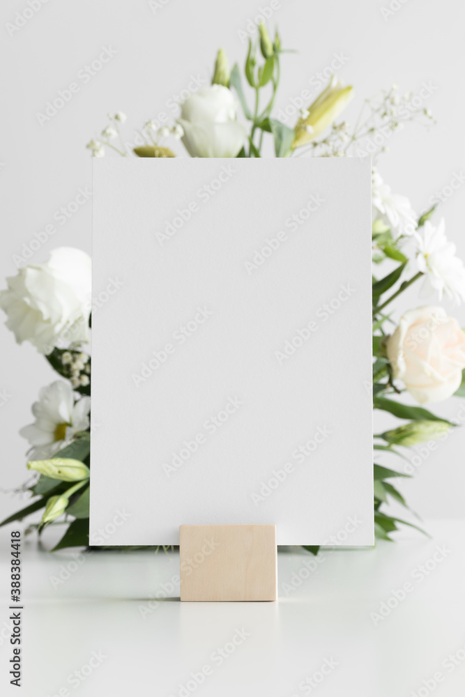 Wedding table number card mockup with a floral arrangement. Wedding table number card mockup with a floral arrangement.