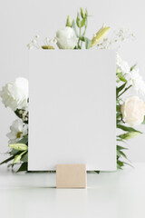 Wedding table number card mockup with a floral arrangement.