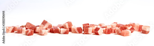 Smoked bacon cubes on kitchen counter, isolated on white background. photo