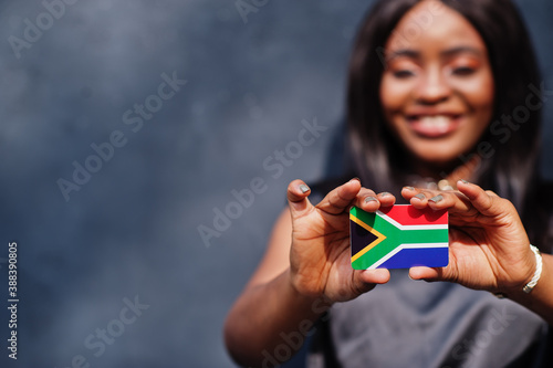 Konstfotografi African woman hold small South Africa flag in hands.