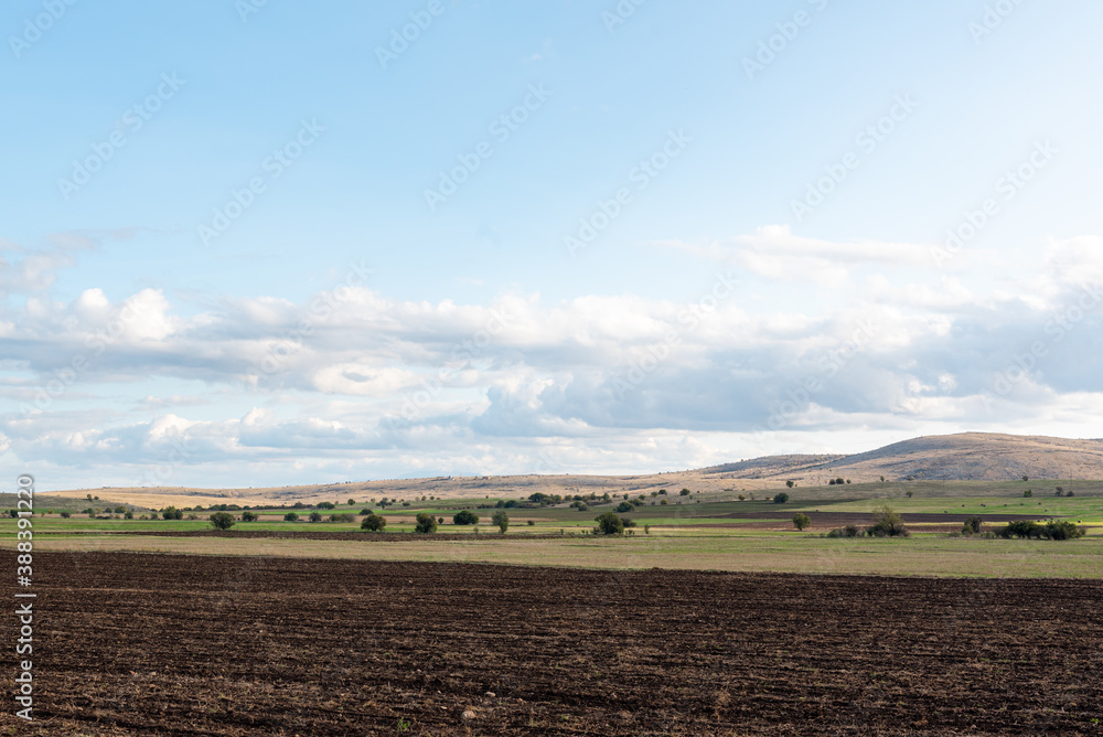 Large farmland hills green blue sky cloudy autumn agriculture farm land landscape clean sharp rural scene