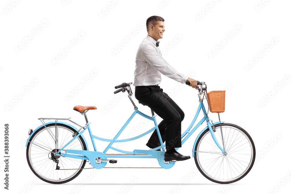 Full length profile shot of a elegant man riding a tandem bicycle Full length profile shot of a elegant man riding a tandem bicycle