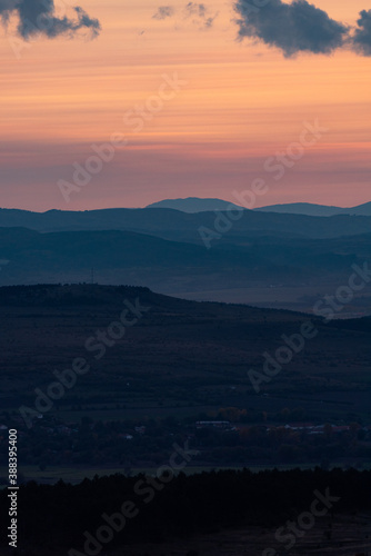 Landscape sunset colors over mountains and hills orange red yellow blue shades natural beauty bulgaria rural © Valentin