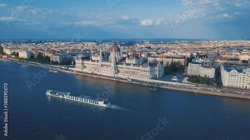 Aerial drone video of Hungarian Parliament building filmed from above with flying videocamera in spring.Parliament of Budapest or Orszaghaz,popular touristis landmark located on banks of Danube photo