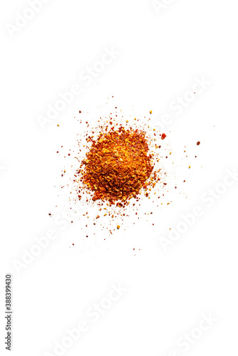 Top view of a pile of organic dry chili flakes isolated on a white background