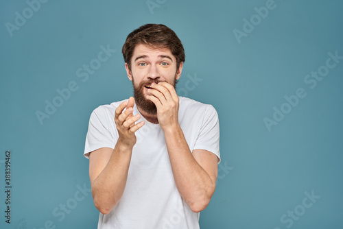 man in white t-shirt gesturing with his hands studio cropped