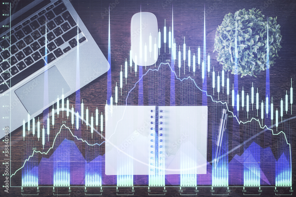 Stock market graph and top view computer on the table background. Double exposure. Concept of financial education. Stock market graph and top view computer on the table background. Double exposure. Concept of financial education.